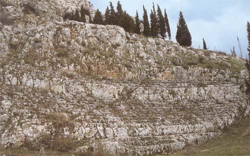 Cheronia, ancient theater. The Hellenistic theater of Cheronia nestles at the base of the rock of the acropolis. CHERONIA (Ancient city) VIOTIA