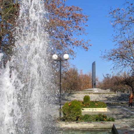 A fountain in Larissa Park. In the back one can see a monument created by the artist Filolaos Tloupas from Larissa., LARISSA (Town) THESSALIA