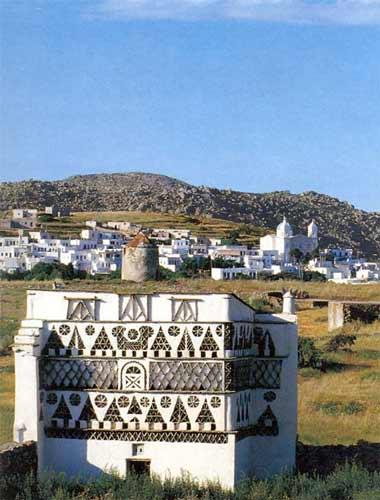 Panormos, a dovecote in the forefront  PANORMOS (Village) TINOS