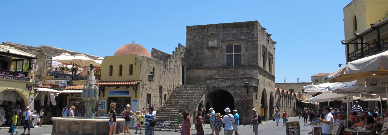 The medieval fountain and Kastellania building (Rhodes Public Library) in Ippokratous Square.